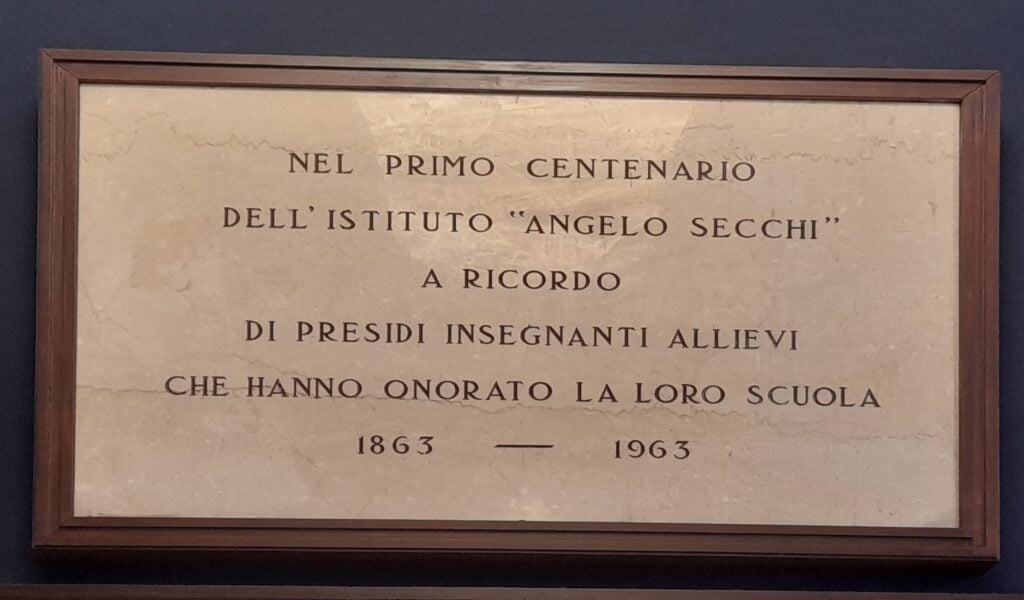 Targa per il centenario della scuola che dice: "Nel primo centenario dell'Istituto Angelo Secchi, a ricordo di presidi insegnanti allievi che hanno onorato la loro scuola. 1863 - 1963"